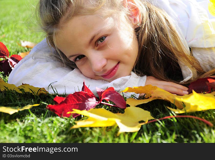 Portrait of girl laying on leaves. Portrait of girl laying on leaves