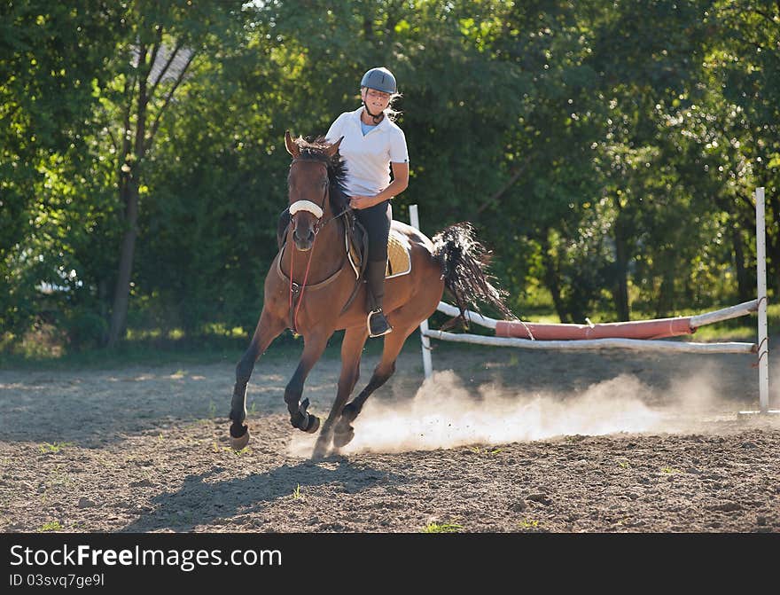 Show jumping.girl riding horse and jumping