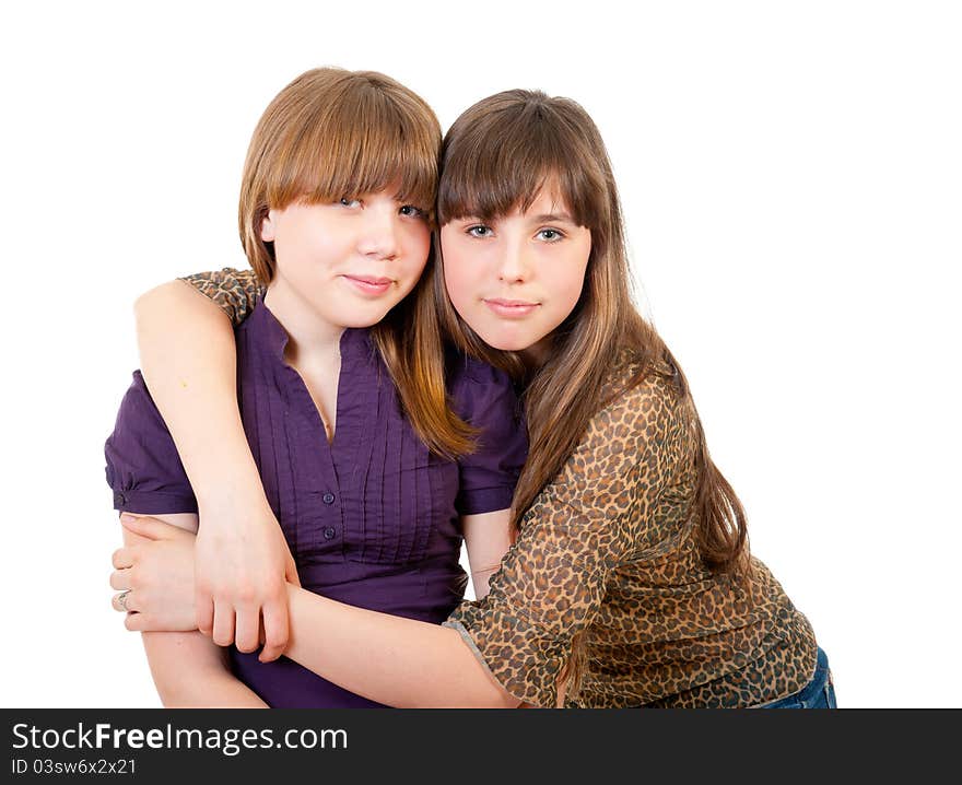 Portrait of two lovely embracing sisters isolated. Portrait of two lovely embracing sisters isolated