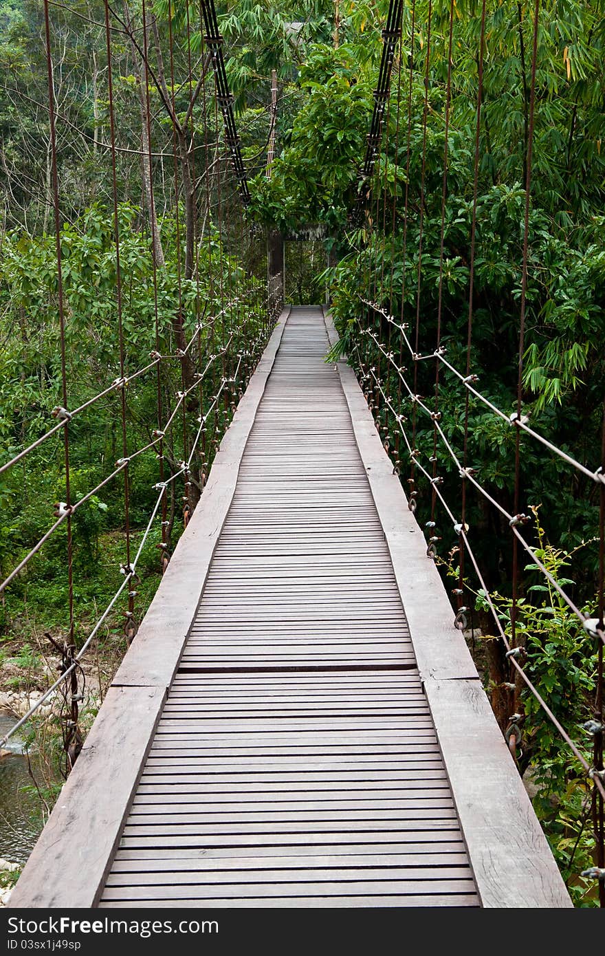 Wooden bridge across a river in thailand