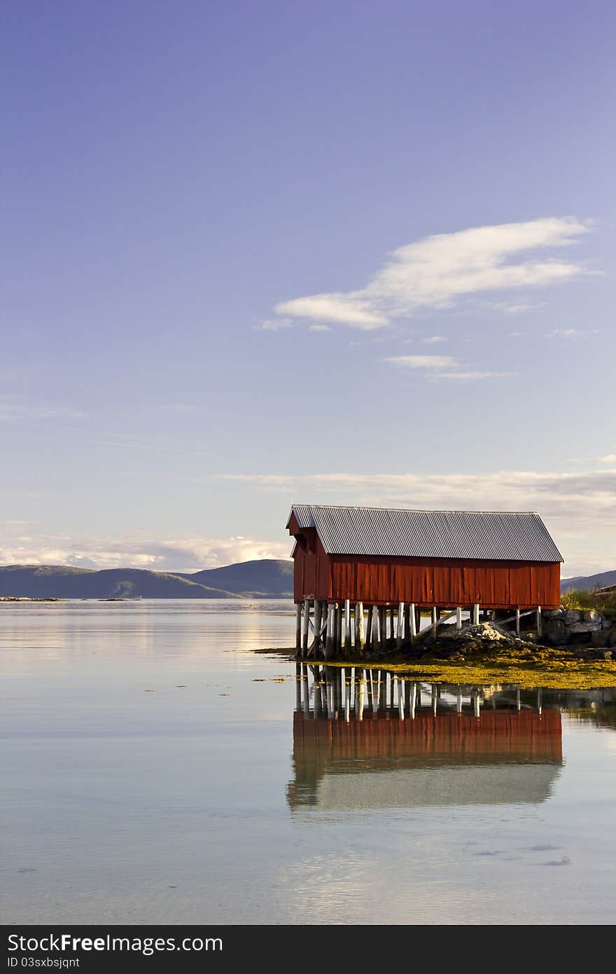 Red boat house reflected, Troms County, Norway