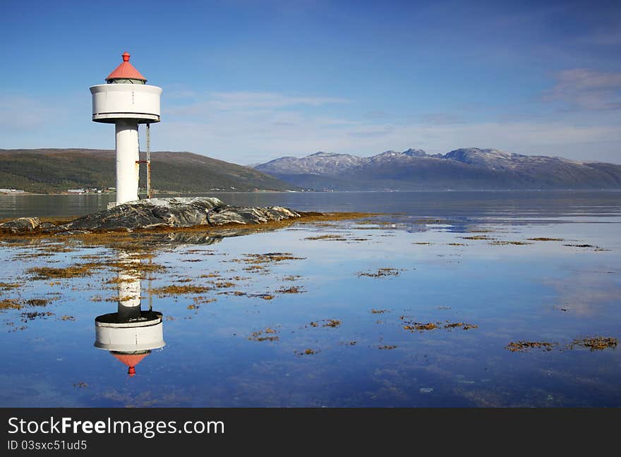 Little white lighthouse in the Norwegian fjords