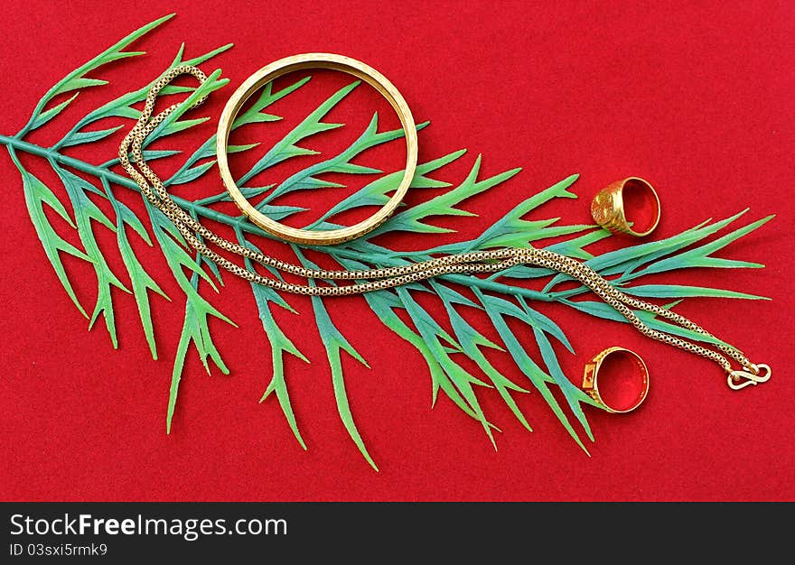 Glitteing gold ornaments displayed on red background