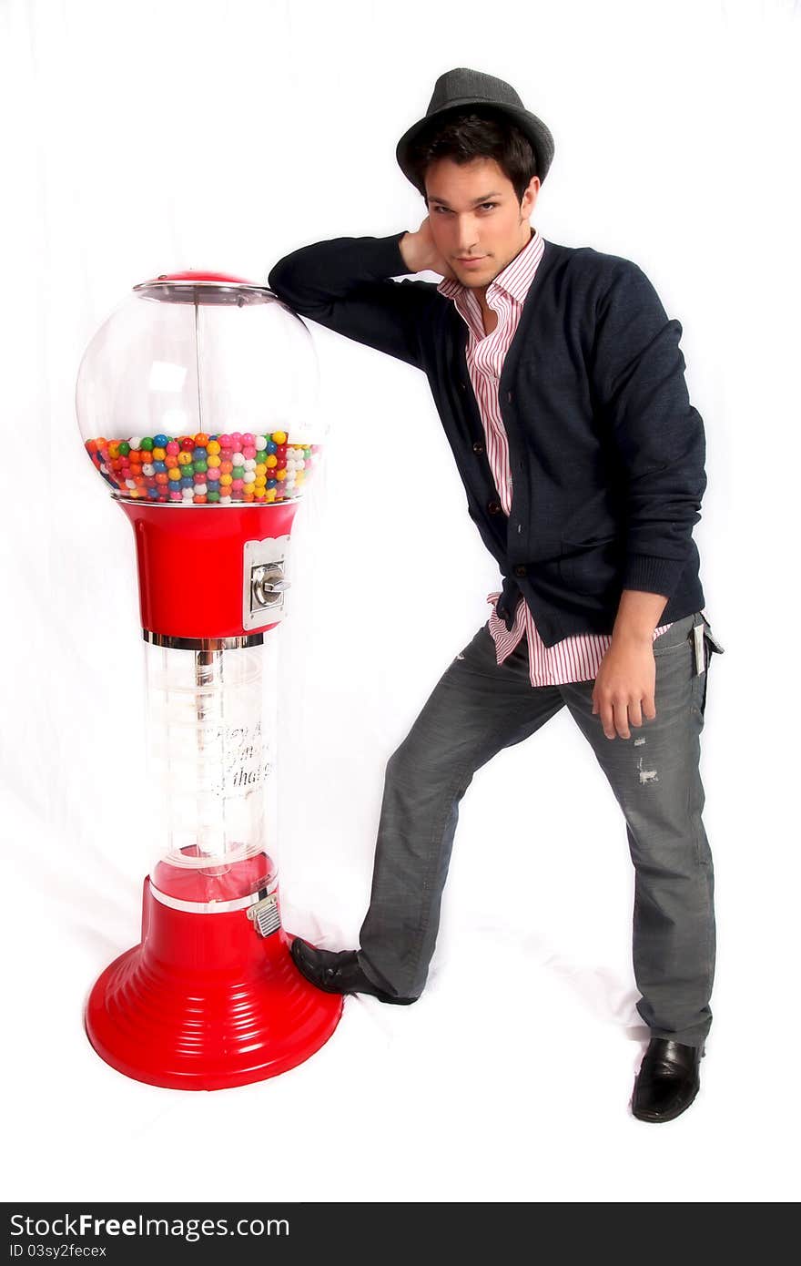 Man leaning on gumball machine against white background. Man leaning on gumball machine against white background.