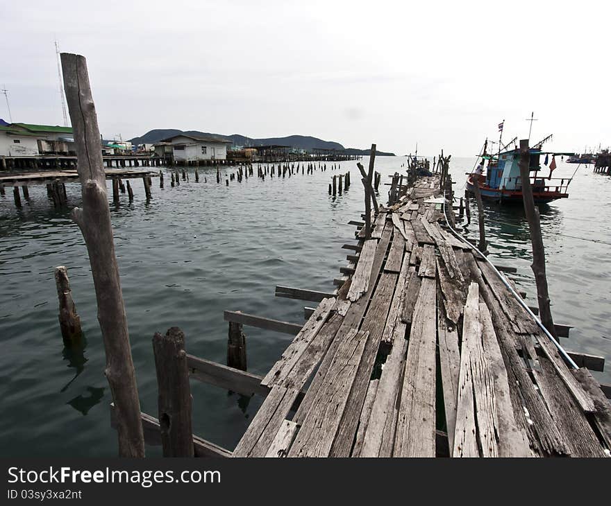 Old wooden fishing bridge to the sea