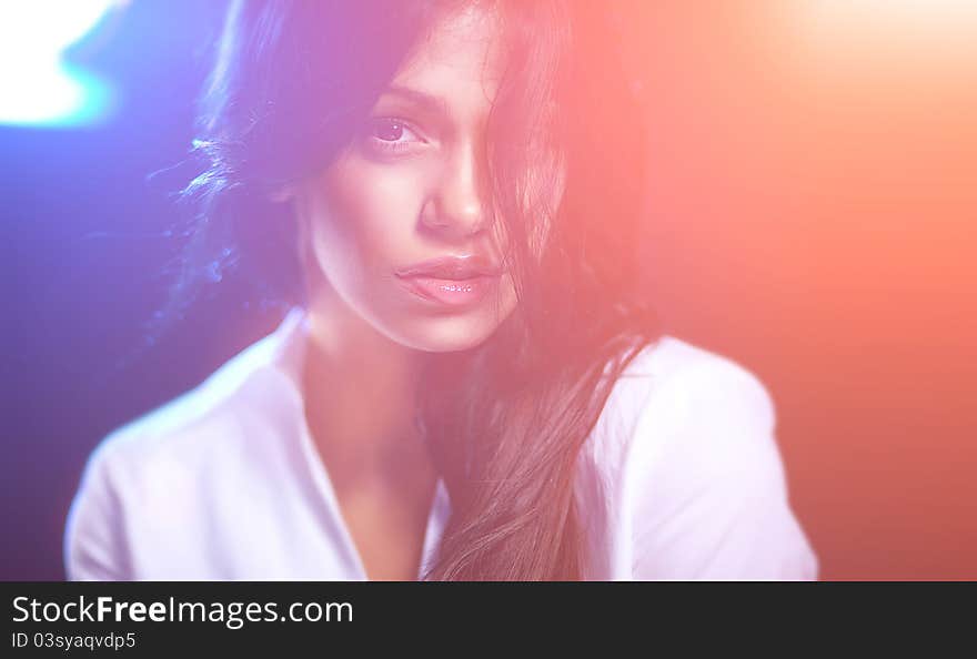 Studio portrait of attractive young woman on dark background