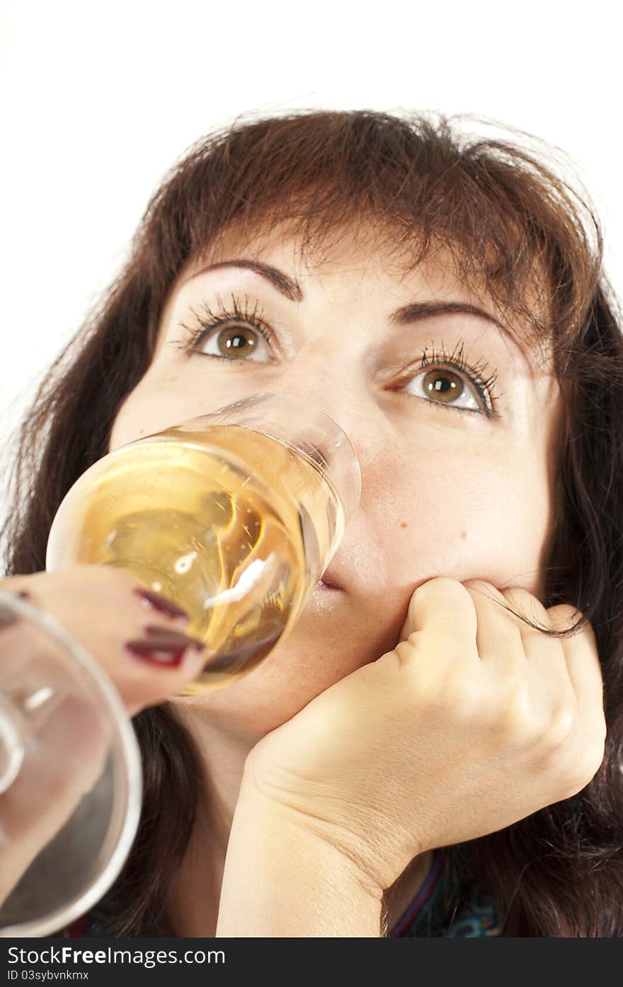 The beautiful young girl drinks champagne from a glass. The beautiful young girl drinks champagne from a glass