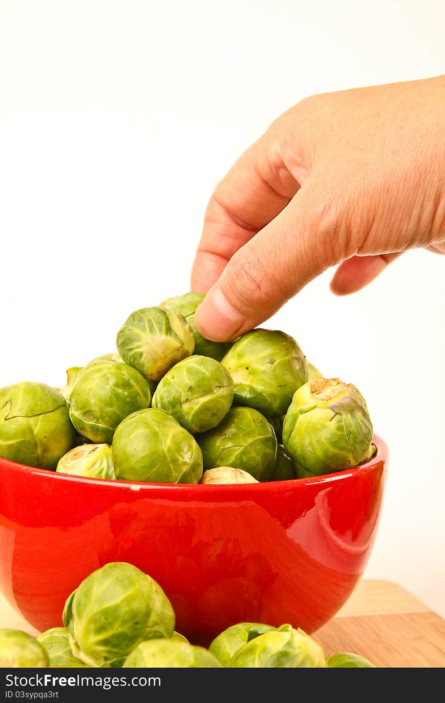 Fresh Brussels sprouts in a bowl. Close up on white background