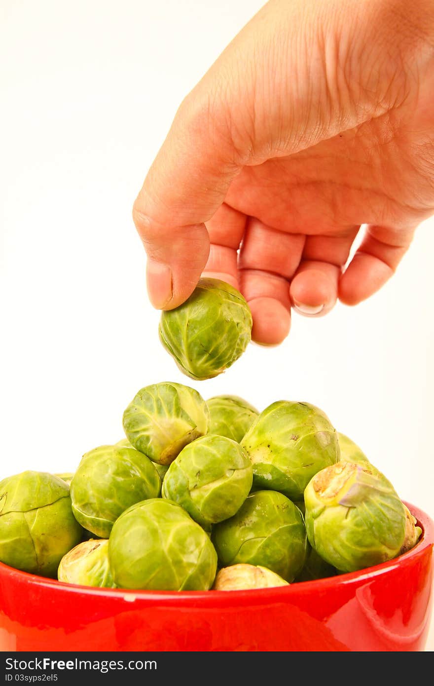 Fresh Brussels sprouts in a bowl. Close up on white background