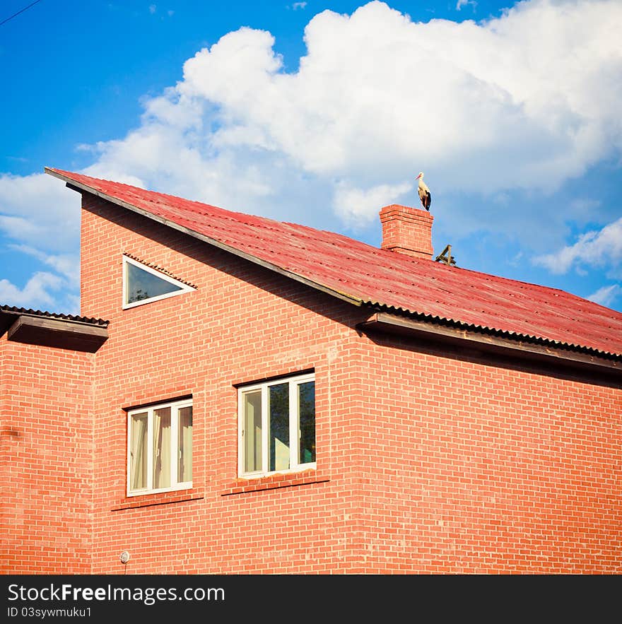 Stork sitting on the top of a roof. Stork sitting on the top of a roof