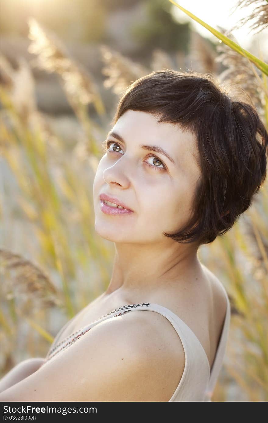 Portrait of beautiful brunette woman in summer