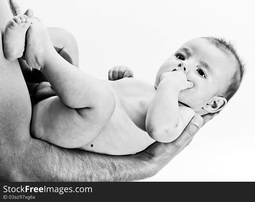 Baby being held by parents on palm - black and white. Baby being held by parents on palm - black and white