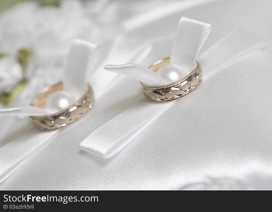 Wedding rings on white pillow