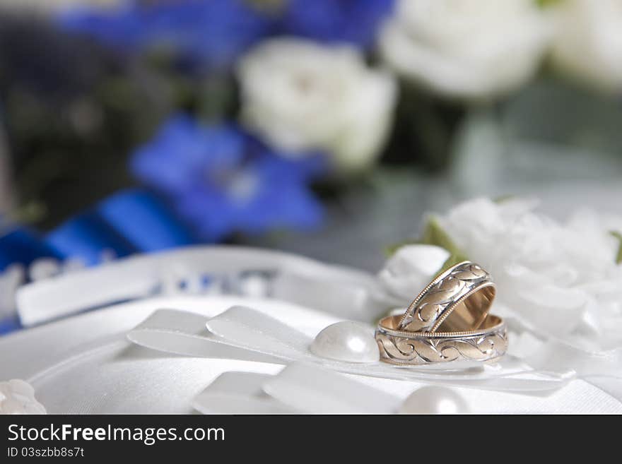 Wedding rings on white pillow