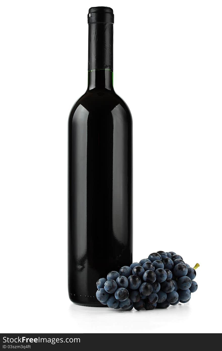 A bottle of red wine and grape on white background. A bottle of red wine and grape on white background.