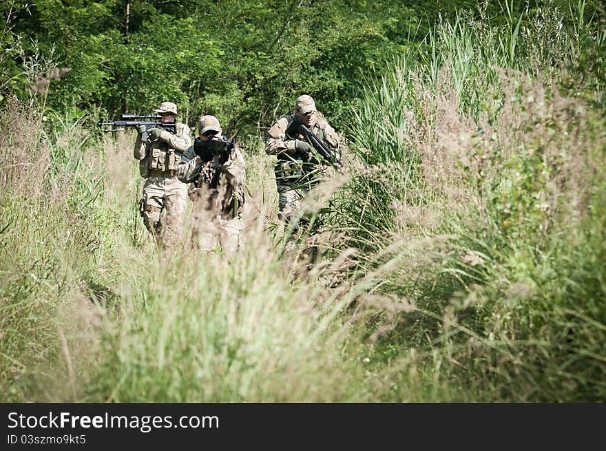 Rebel soldiers during patrol on battle field, aiming on enemy. Rebel soldiers during patrol on battle field, aiming on enemy