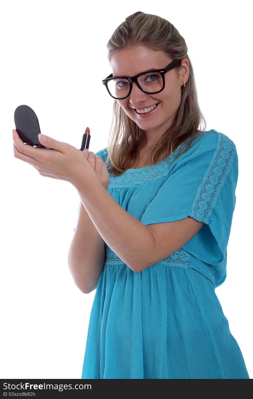 Happy woman applying lipstick and holding a compact