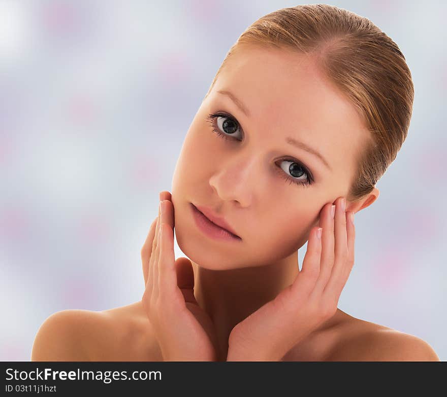 Portrait of a beautiful young healthy girl on a background of pale color. Portrait of a beautiful young healthy girl on a background of pale color