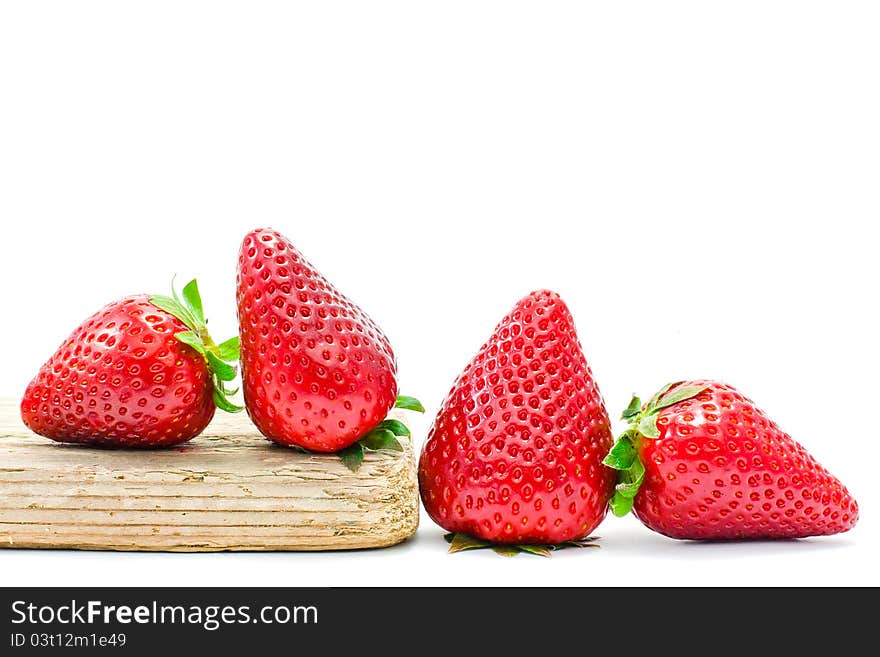 Group of strawberries over a piece of old wood. Group of strawberries over a piece of old wood