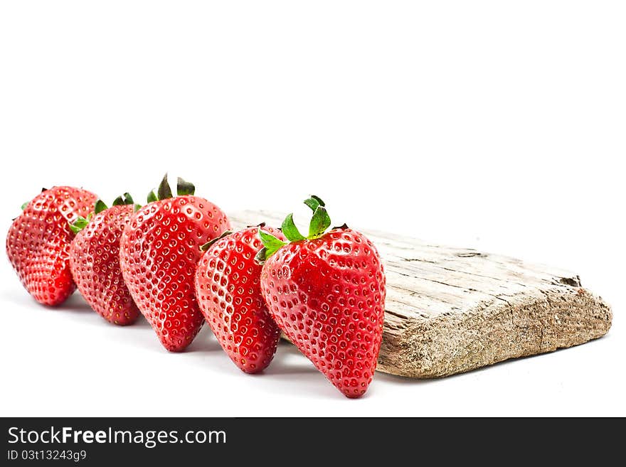 Group of strawberries over a piece of old wood. Group of strawberries over a piece of old wood