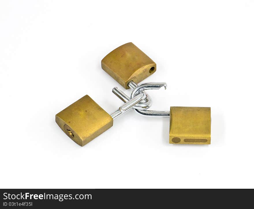 Three linked brass padlocks on a white background