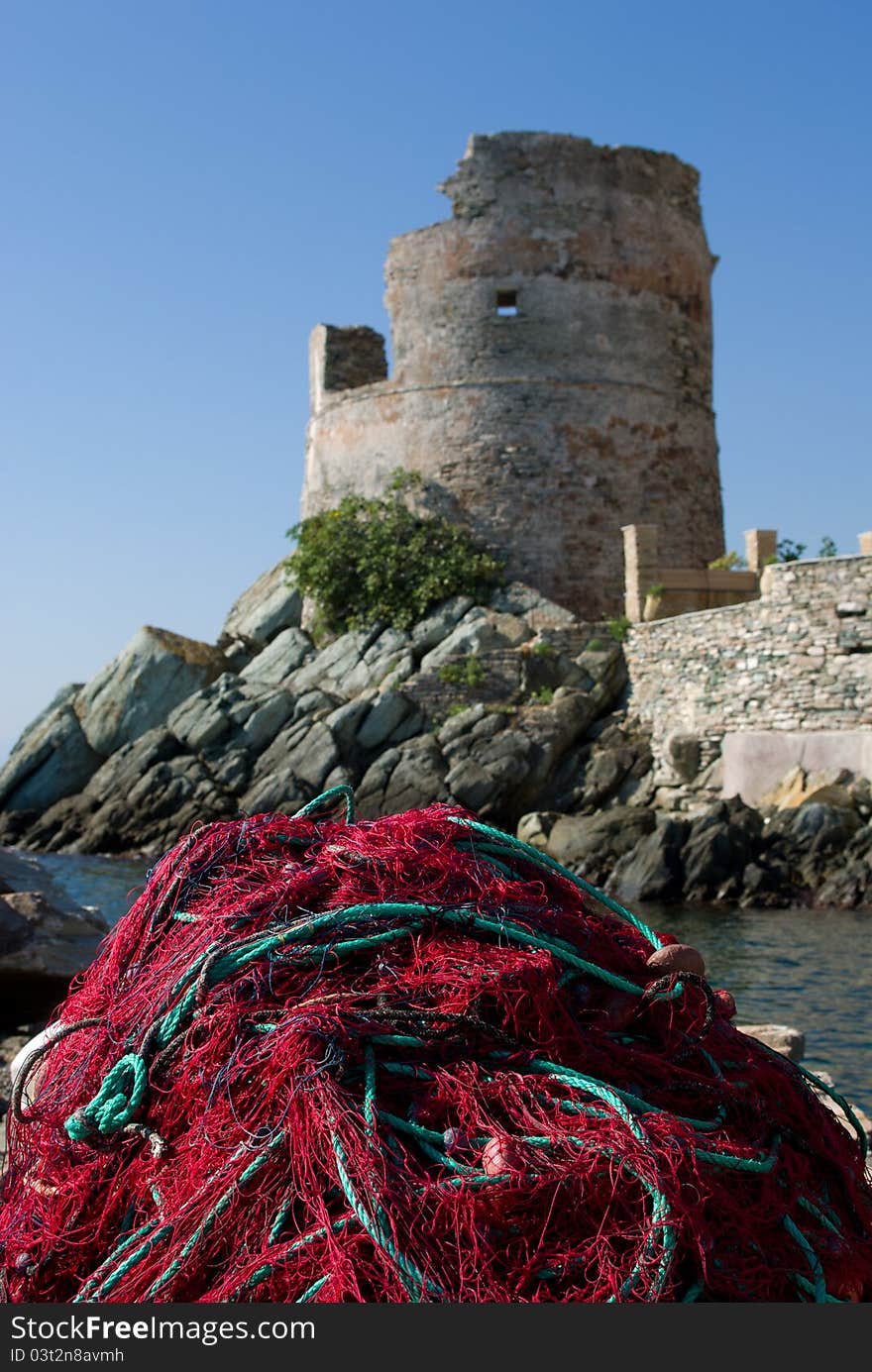 Fishing net on the mole under an ancient tower