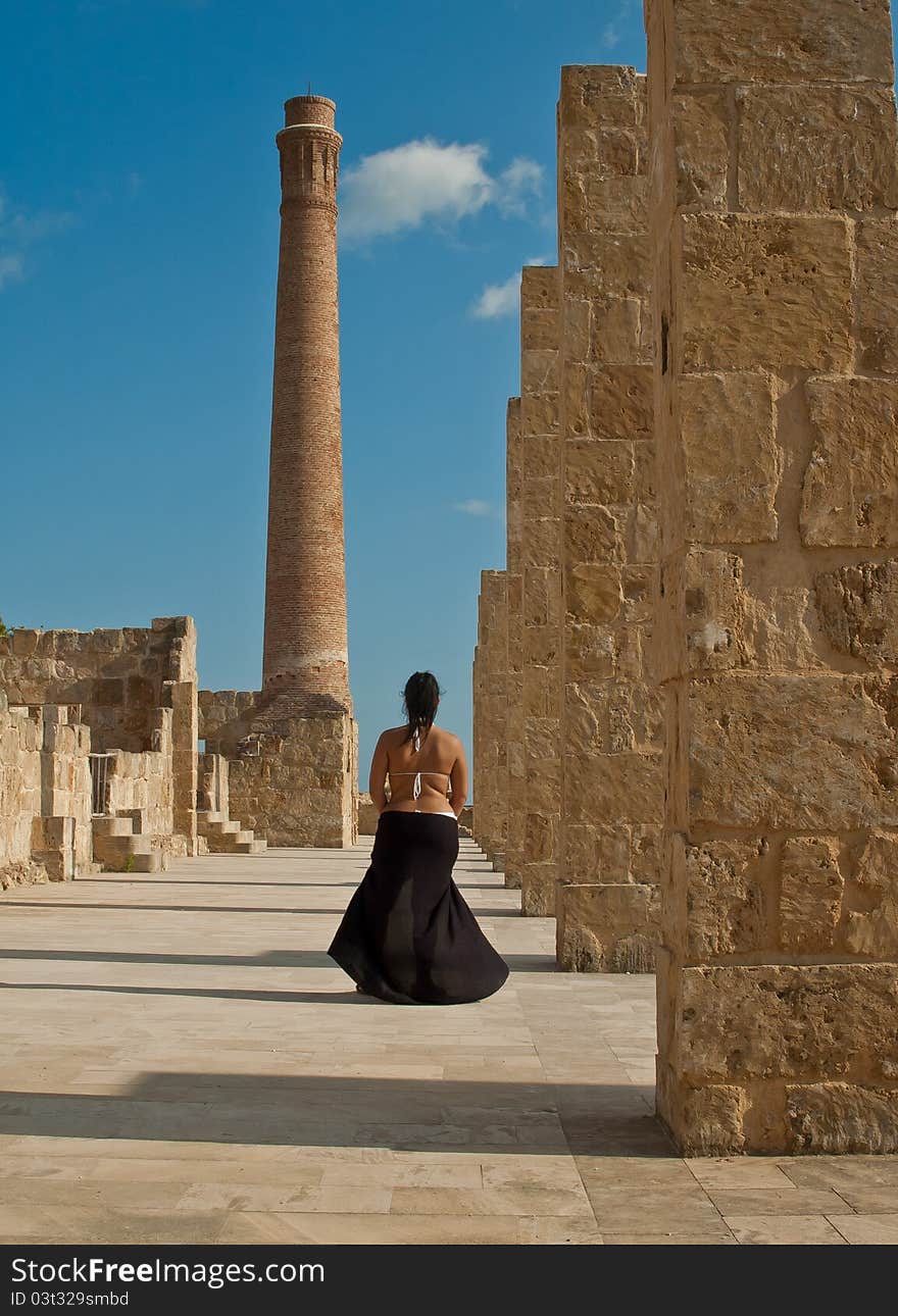 Walking woman on tuna fishing ruins in natural oasis of vendicari during sunset. Walking woman on tuna fishing ruins in natural oasis of vendicari during sunset