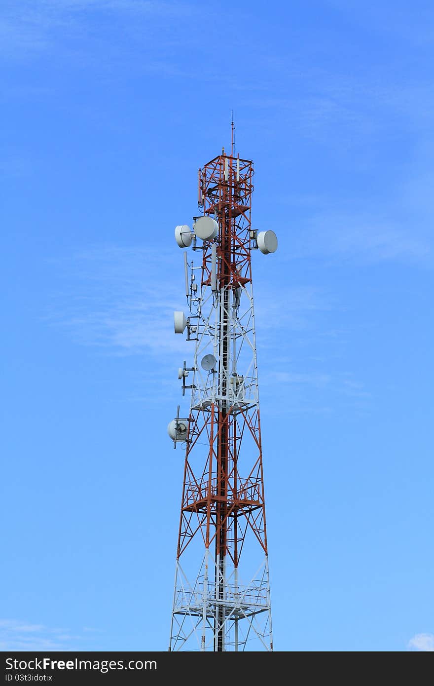 Telecommunication tower with blue sky background.