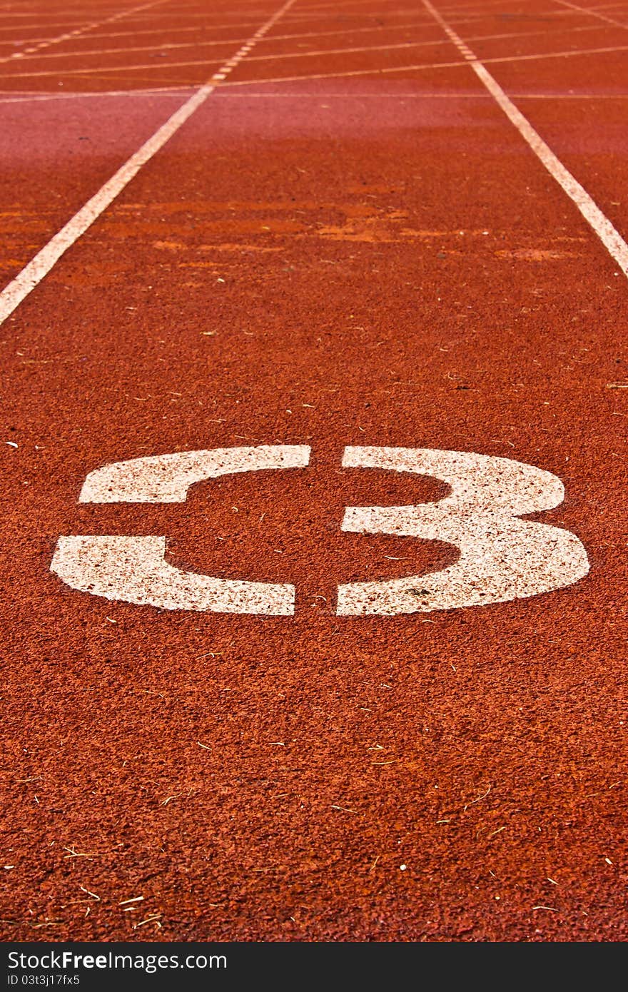 Number three on the start of a running track for background used