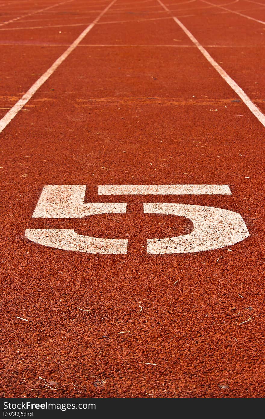 Number five on the start of a running track for background used