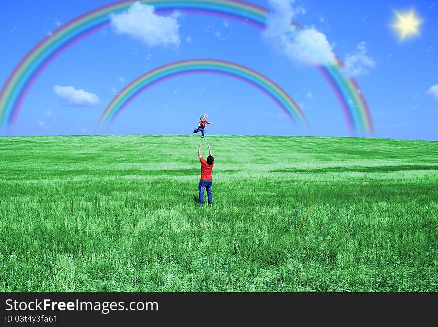 Father and daughter playing in the meadow