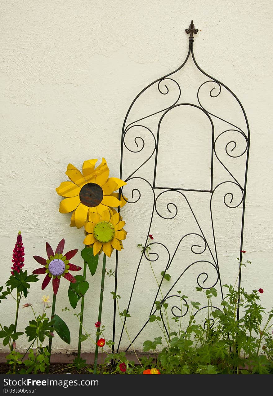 White wall with metal flowers and trellis. White wall with metal flowers and trellis.