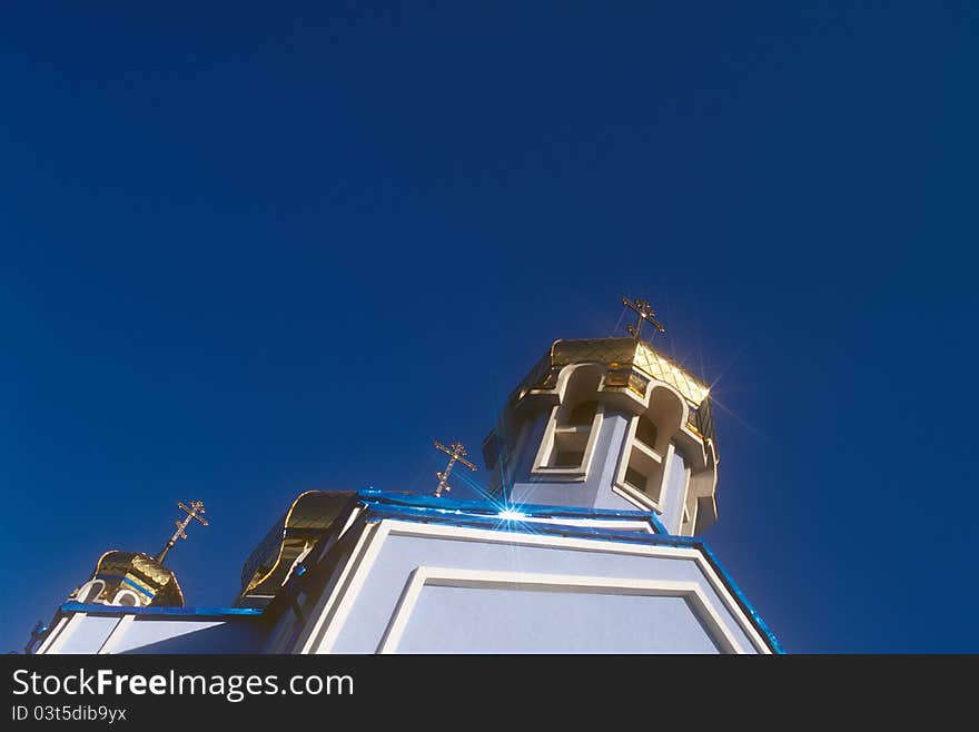 Gold domes of the orthodox church against the clear blue sky. Tyachiv, Zakarpattia, Ukraine. Gold domes of the orthodox church against the clear blue sky. Tyachiv, Zakarpattia, Ukraine.