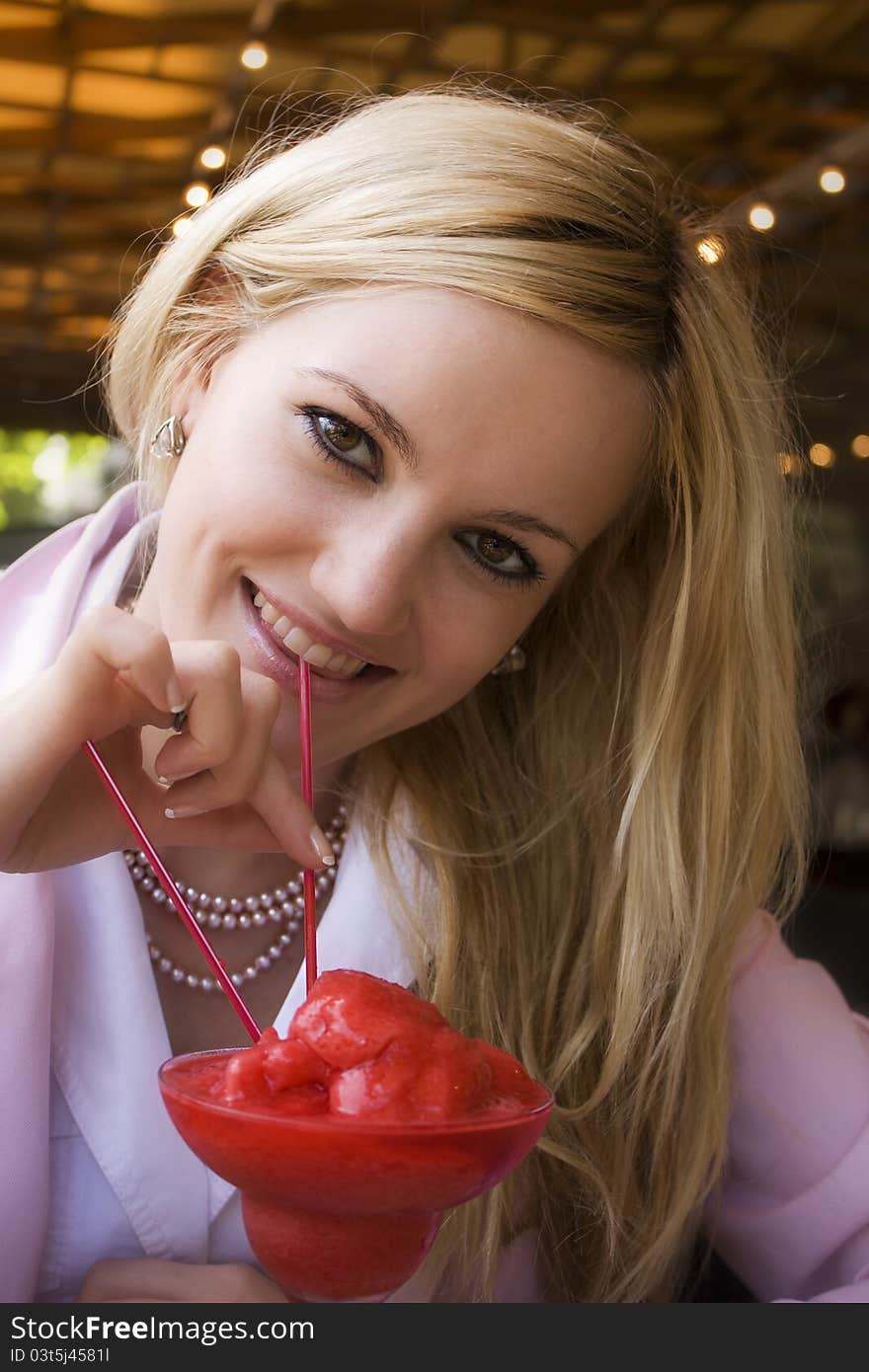 Gorgeous blonde girl enjoying strawberry cocktail. Gorgeous blonde girl enjoying strawberry cocktail