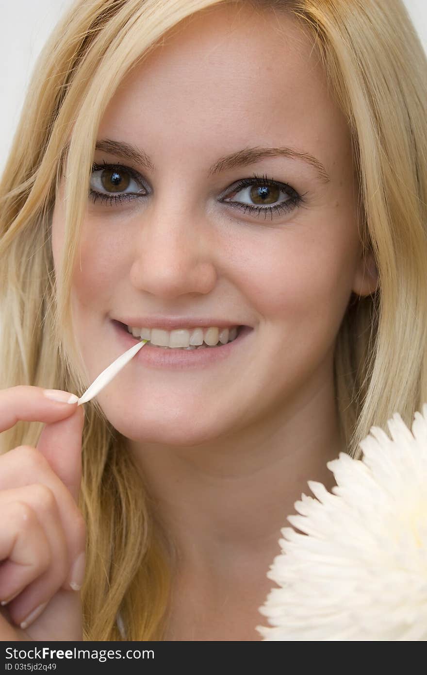 Beautiful blonde girl with daisy petal. Beautiful blonde girl with daisy petal