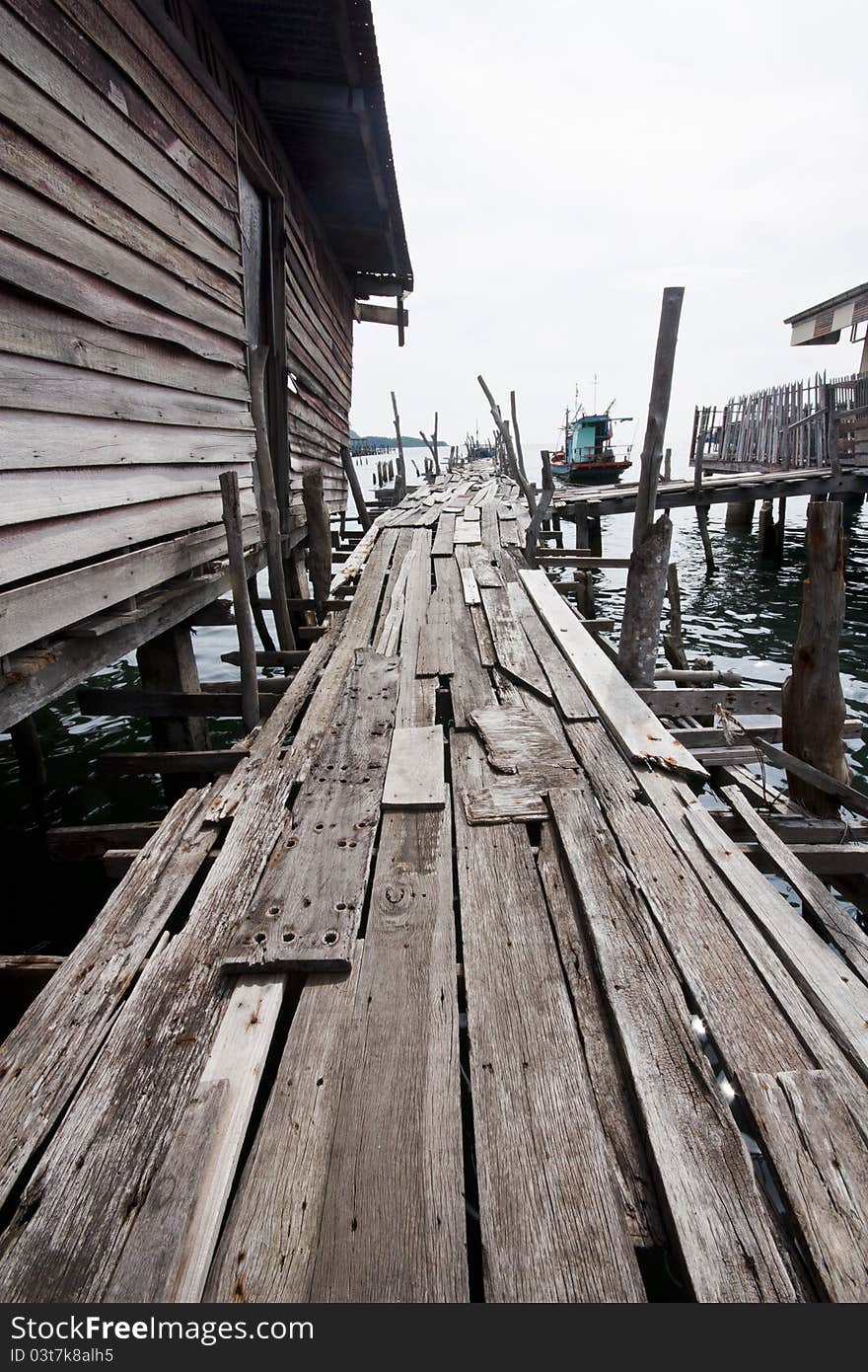 Old wooden fishing bridge to the sea