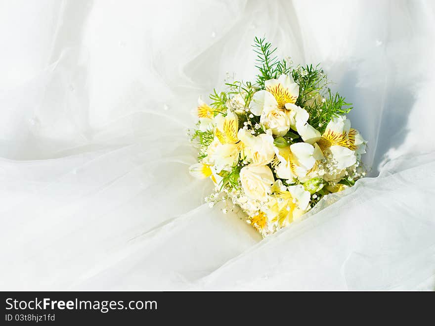 Bridal bouquet of roses on a wedding dress. Bridal bouquet of roses on a wedding dress