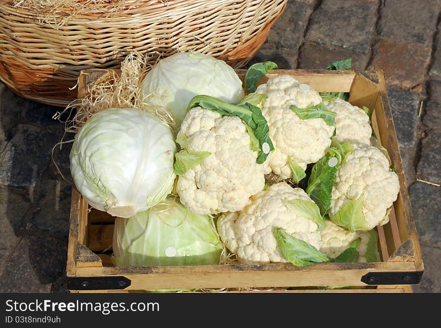 Two kinds of cabbage in a box on a market