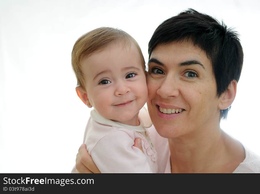 A mother playing with her little baby on white background. A mother playing with her little baby on white background