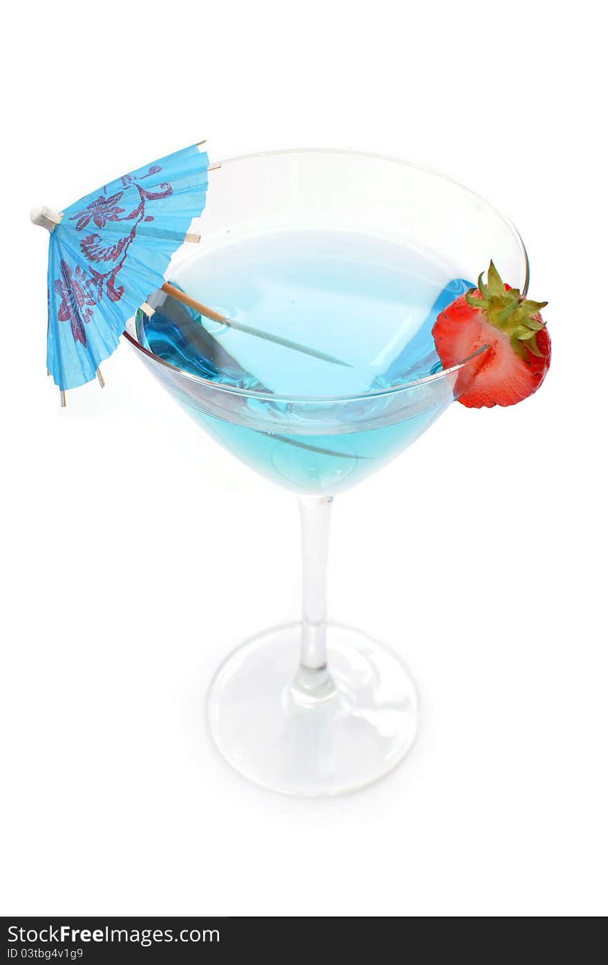 Blue cocktail with a slice strawberry and umbrella