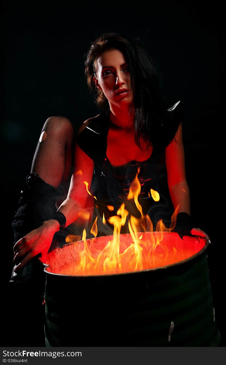 Beautiful Woman And Iron Barrel With Fire Inside