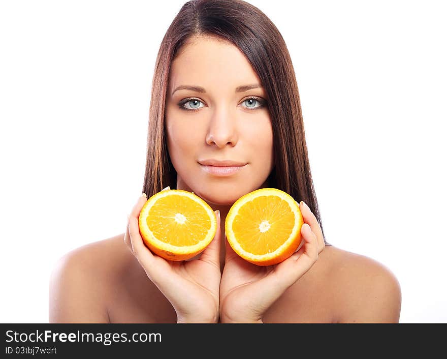 Beautiful woman with orange in hands against white background