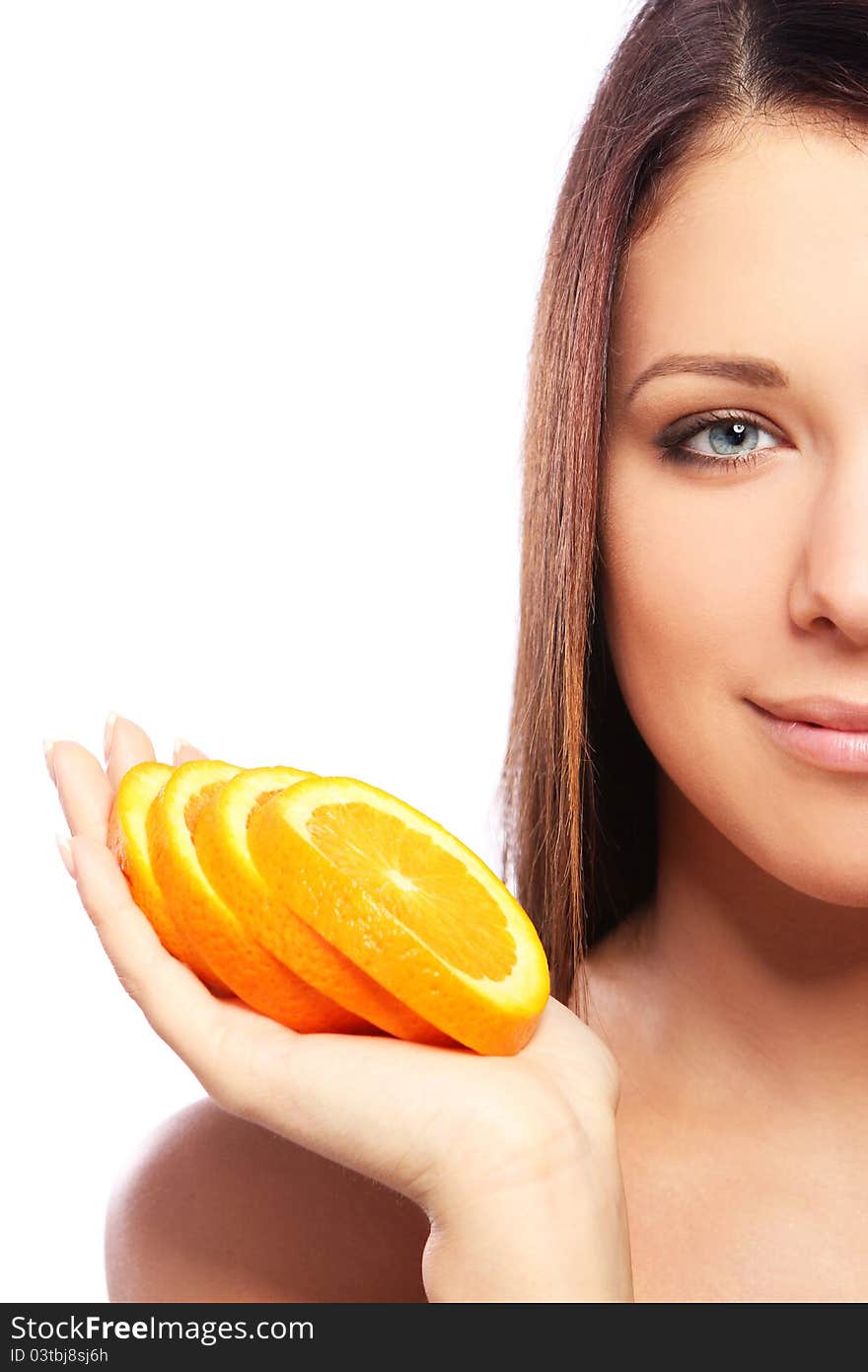 Beautiful woman with orange in hands against white background