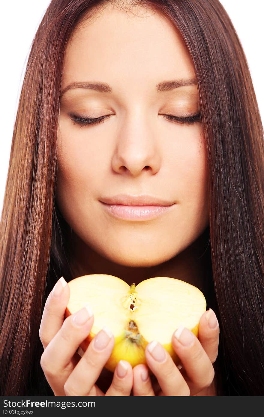 Beautiful woman with apple in hands against white background