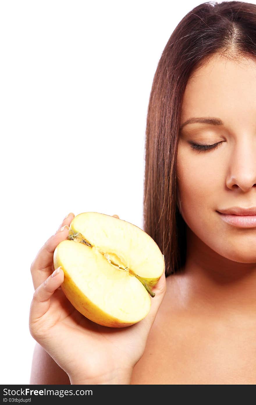 Beautiful woman with apple in hands against white background