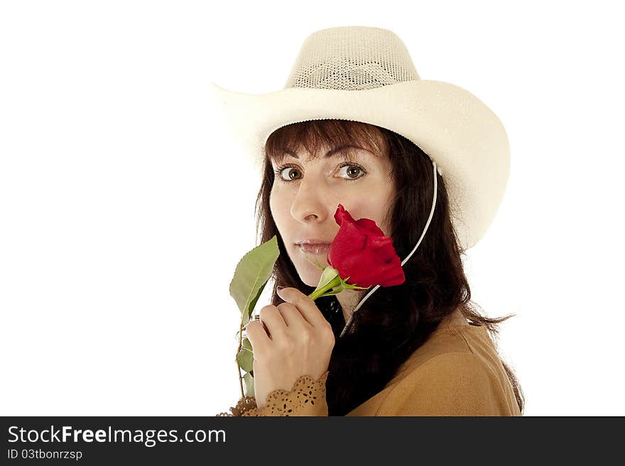 The young girl in a white hat holds a red rose at the person. The young girl in a white hat holds a red rose at the person