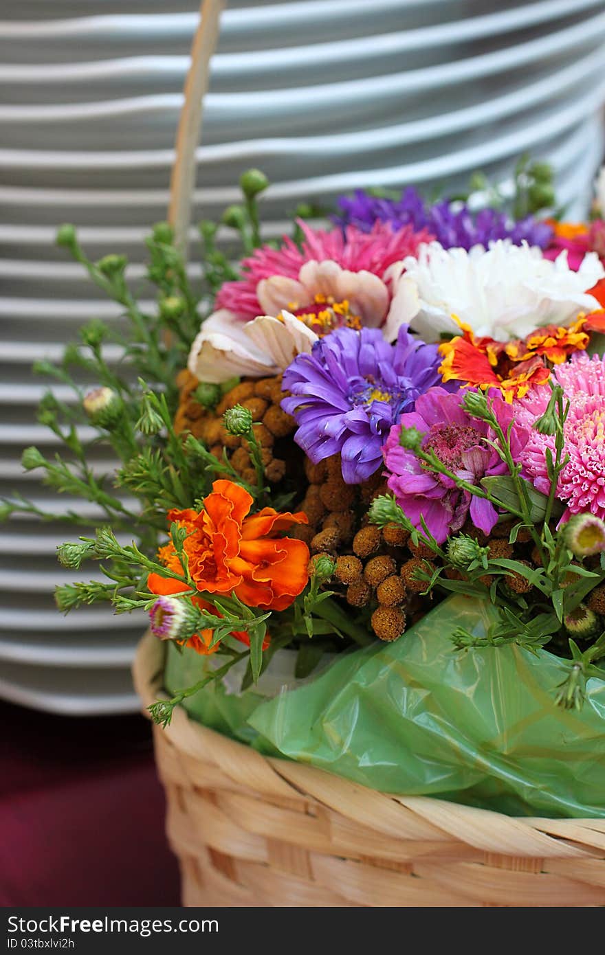 Decorative flower basket and white plates on dinner table. Decorative flower basket and white plates on dinner table.