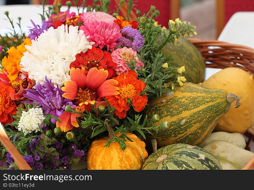 Colorful flower and pumpkin basket on outdoor table. Colorful flower and pumpkin basket on outdoor table.