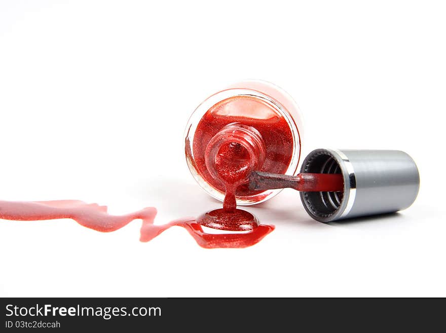 Open nail polish bottle with dropping red glitter nail polish as closeup on white background. Open nail polish bottle with dropping red glitter nail polish as closeup on white background