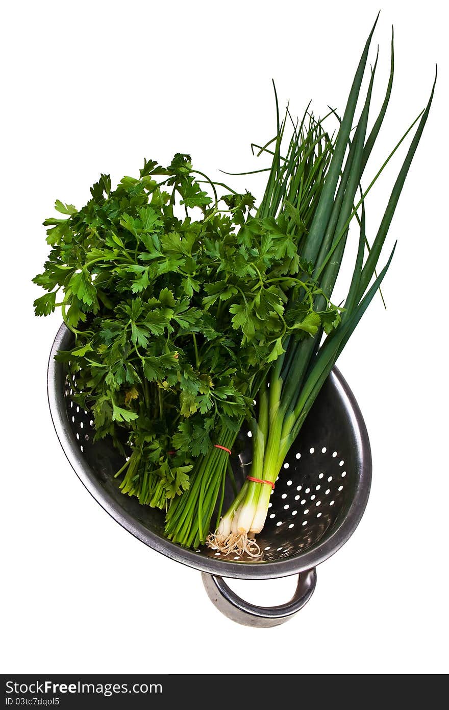 Chive,bulb onion and parsley bundles in colander isolated over white background. Chive,bulb onion and parsley bundles in colander isolated over white background.